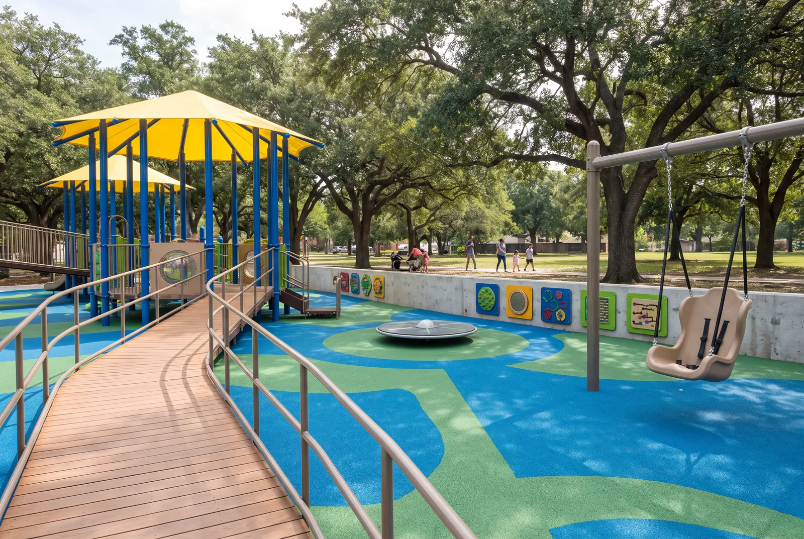 An inclusive park playground with a wide ramp, a flush spinner, sensory panels and an adaptive swing on blue and green rubber surfacing